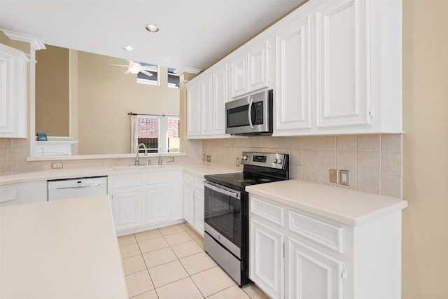 kitchen with ceiling fan, white cabinetry, stainless steel appliances, and light tile patterned floors