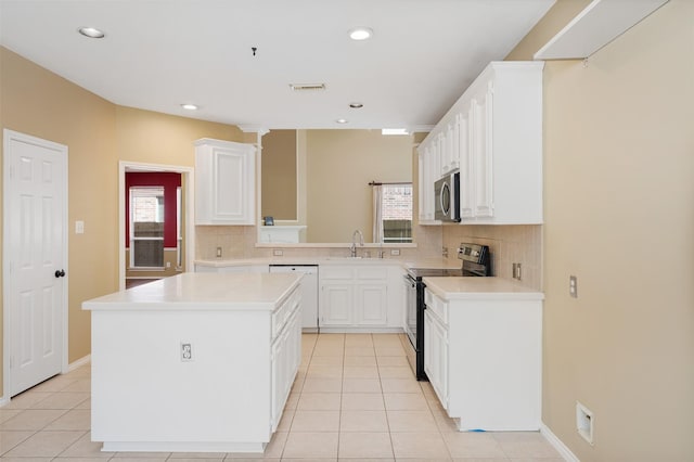 kitchen with a center island, white cabinets, plenty of natural light, and black range with electric cooktop