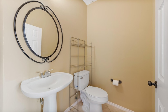 bathroom featuring tile patterned flooring and toilet