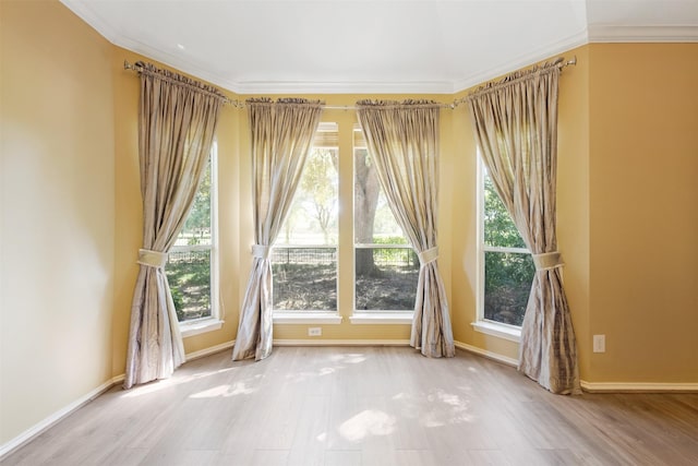 unfurnished room with wood-type flooring and ornamental molding