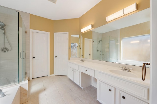 bathroom with tile patterned flooring, vanity, and independent shower and bath