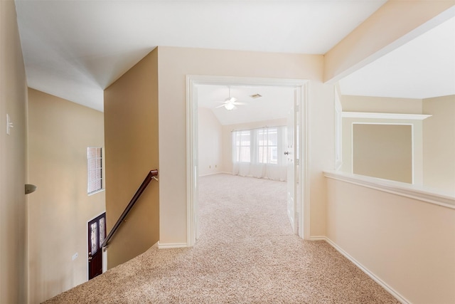 hallway featuring carpet floors and vaulted ceiling