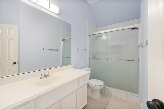 bathroom featuring tile patterned flooring, vanity, toilet, and walk in shower