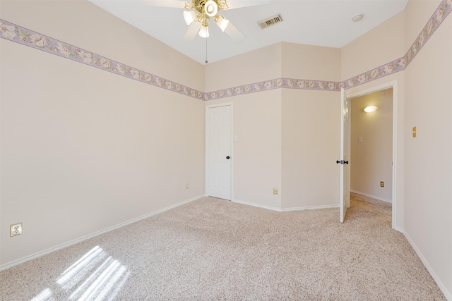 spare room featuring ceiling fan and light carpet