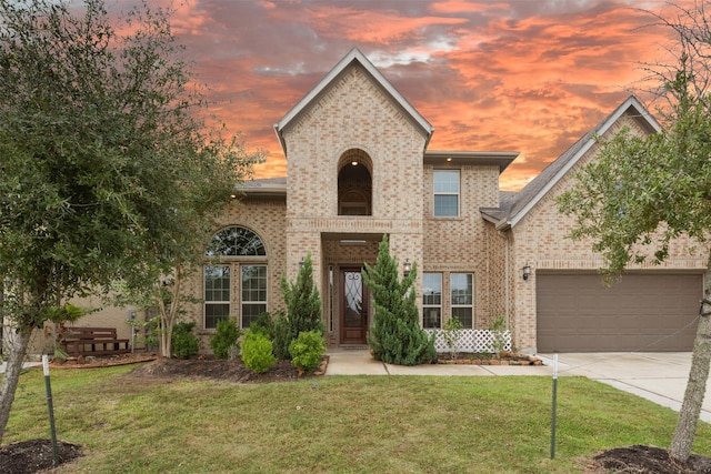 view of front of house with a garage and a lawn