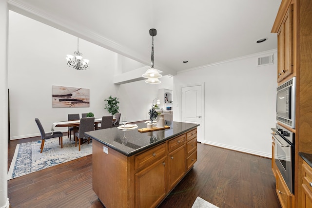 kitchen with a center island, stainless steel appliances, dark wood-type flooring, crown molding, and pendant lighting