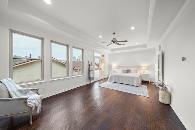 bedroom featuring a tray ceiling, ceiling fan, dark hardwood / wood-style flooring, and ornamental molding