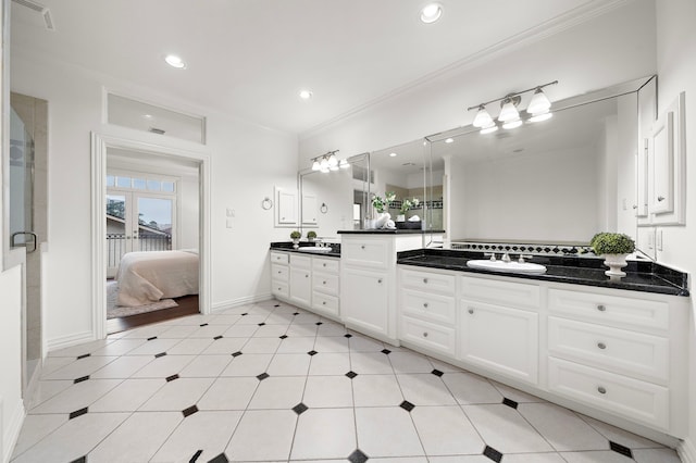 bathroom featuring crown molding, french doors, and vanity