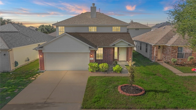 view of front property featuring a lawn and a garage