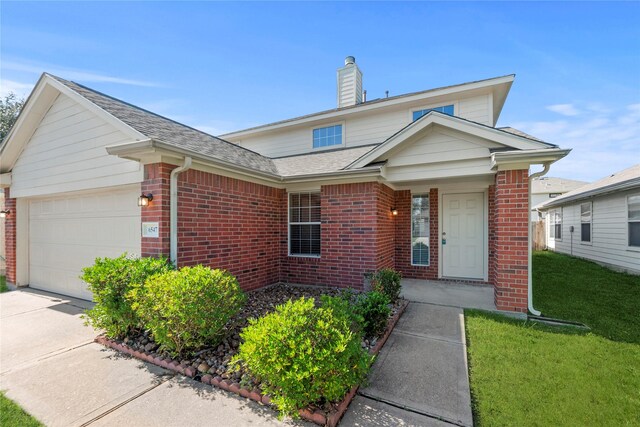 view of front of home featuring a garage and a front lawn