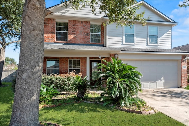 view of front of property featuring a front lawn and a garage