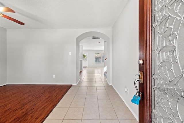 tiled entryway featuring ceiling fan and a textured ceiling