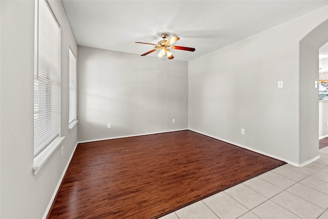 unfurnished room featuring ceiling fan and light tile patterned floors