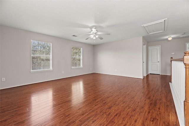 unfurnished living room with ceiling fan and dark wood-type flooring