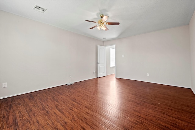 unfurnished room with ceiling fan and dark wood-type flooring