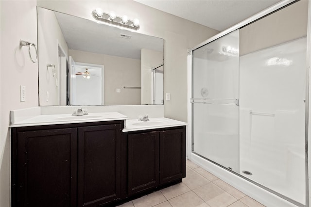 bathroom with walk in shower, vanity, tile patterned floors, and ceiling fan