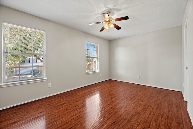 empty room featuring ceiling fan and dark wood-type flooring