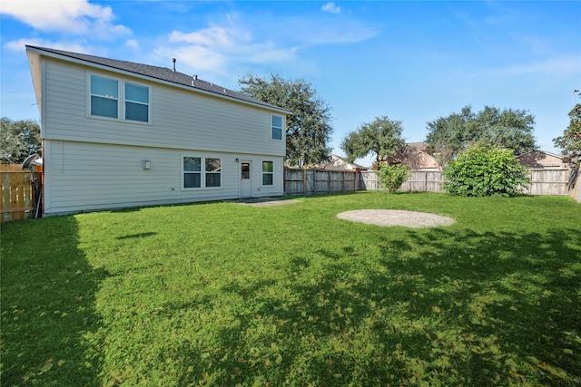 rear view of property featuring a yard and a patio