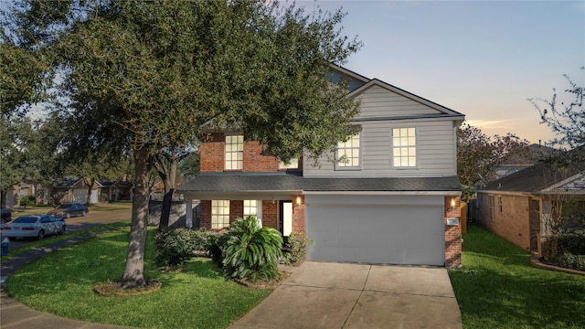 view of front of property featuring a garage and a yard