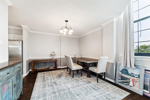 dining space featuring a textured ceiling, dark hardwood / wood-style floors, an inviting chandelier, and ornamental molding