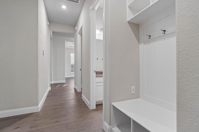 mudroom featuring baseboards and wood finished floors