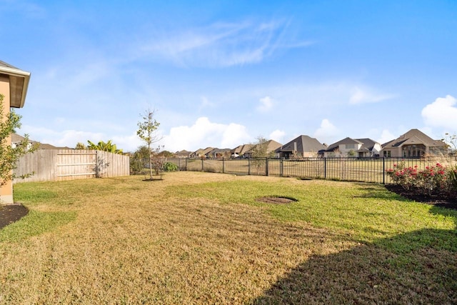 view of yard with a residential view and a fenced backyard