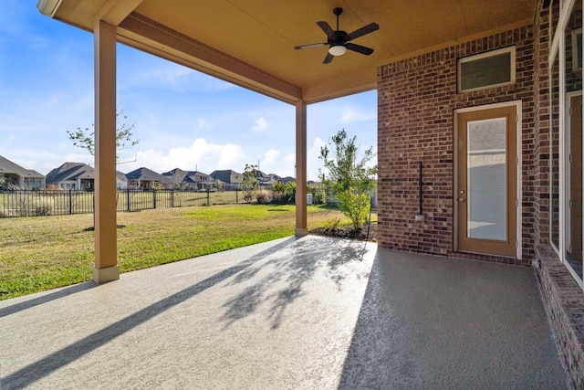 view of patio / terrace featuring a residential view, fence, and a ceiling fan