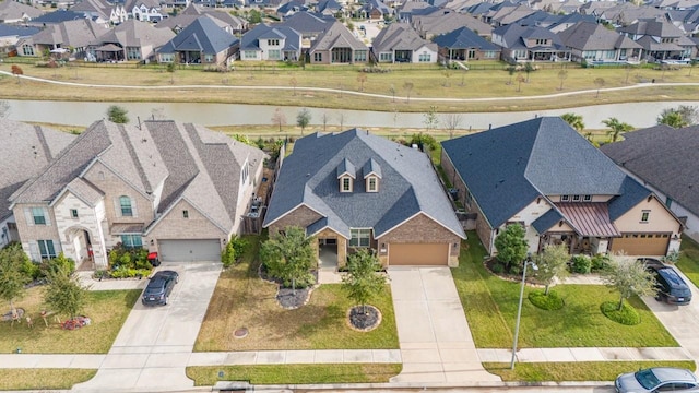 aerial view featuring a water view and a residential view