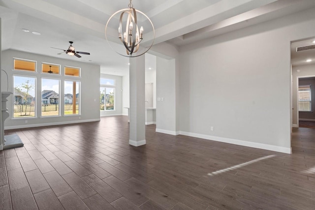 unfurnished living room with dark wood-style floors, baseboards, visible vents, and a raised ceiling