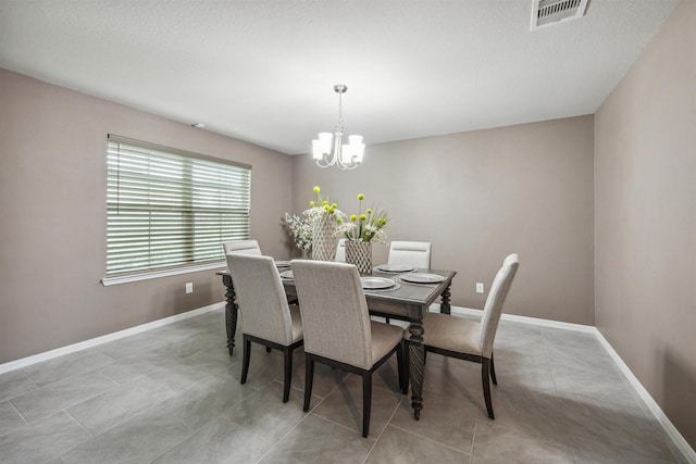 tiled dining area with a notable chandelier