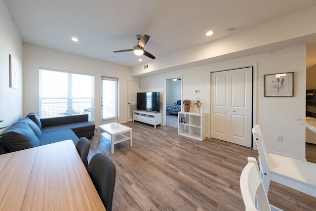 living room featuring ceiling fan and hardwood / wood-style flooring