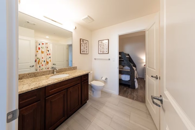 bathroom featuring a shower with curtain, vanity, and toilet