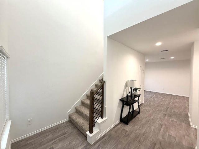 staircase with wood-type flooring