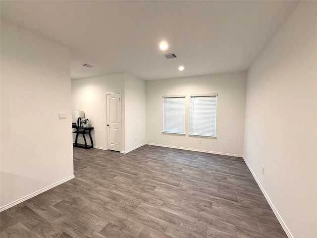 empty room featuring dark wood-type flooring