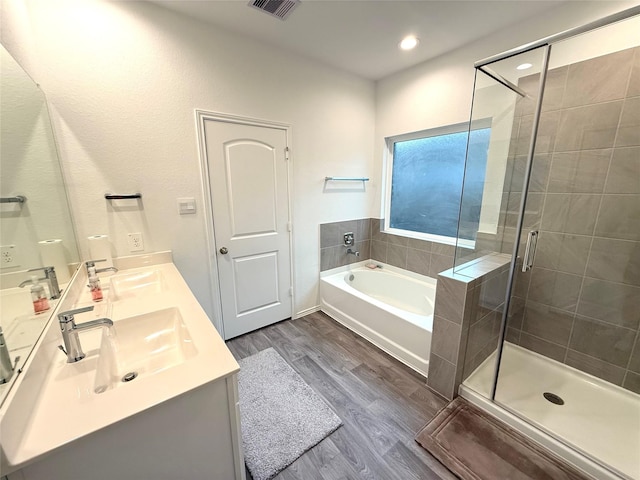 bathroom featuring vanity, independent shower and bath, and hardwood / wood-style flooring