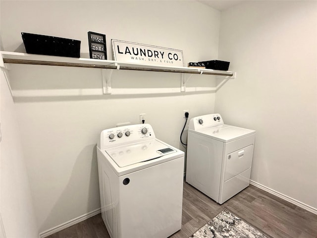 clothes washing area with independent washer and dryer and wood-type flooring