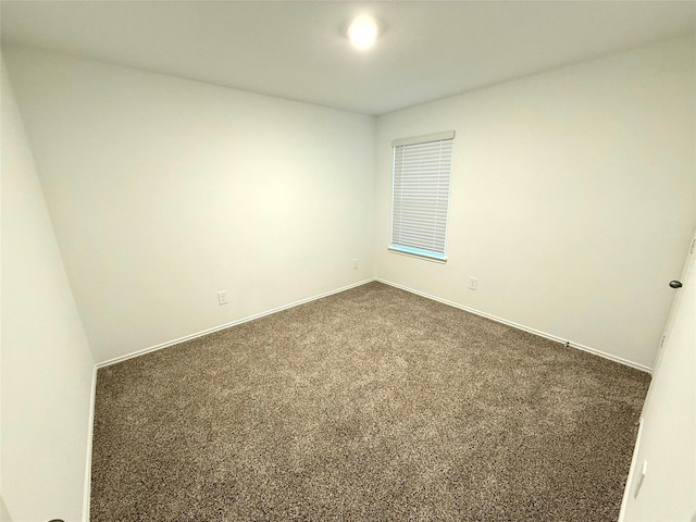 empty room featuring dark carpet