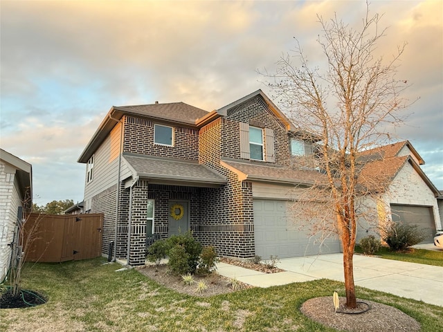 view of front of property with a yard and a garage