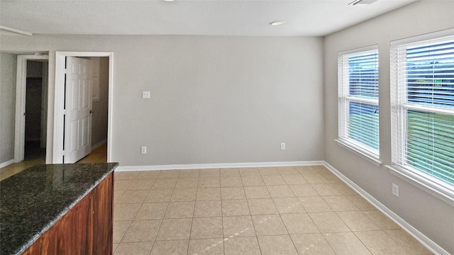 unfurnished room featuring light tile patterned floors