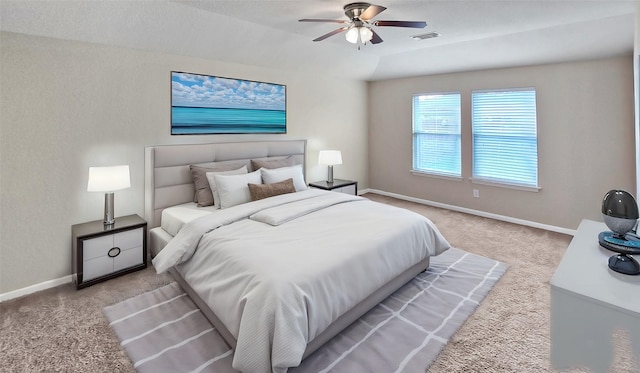 carpeted bedroom with ceiling fan and lofted ceiling