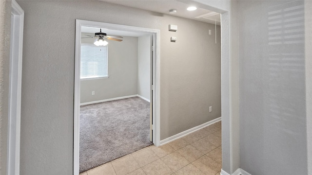 hall featuring light colored carpet