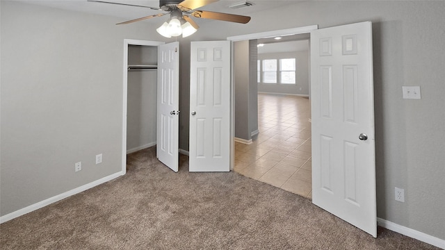 unfurnished bedroom with light carpet, a closet, and ceiling fan