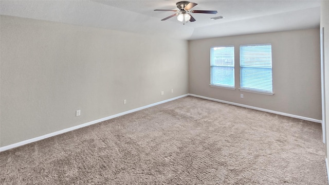 carpeted spare room featuring ceiling fan and vaulted ceiling