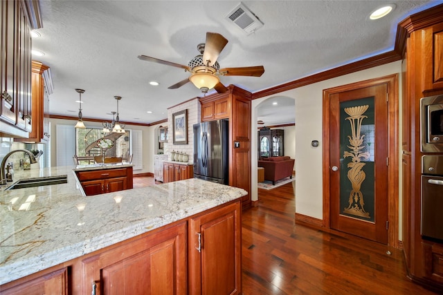 kitchen with sink, hanging light fixtures, stainless steel appliances, kitchen peninsula, and crown molding