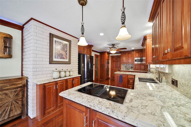 kitchen with ceiling fan, sink, stainless steel appliances, tasteful backsplash, and pendant lighting