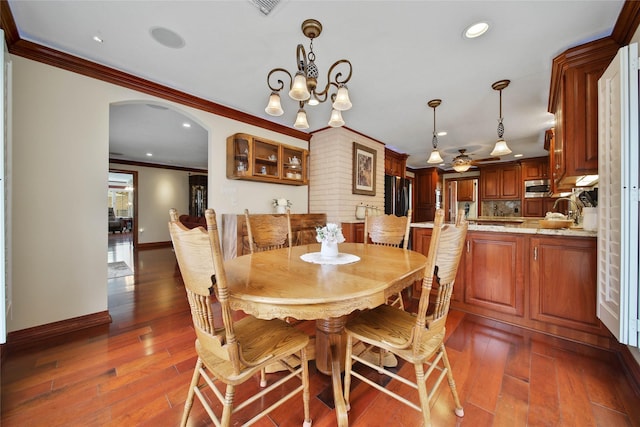 dining room featuring an inviting chandelier, dark hardwood / wood-style floors, and ornamental molding