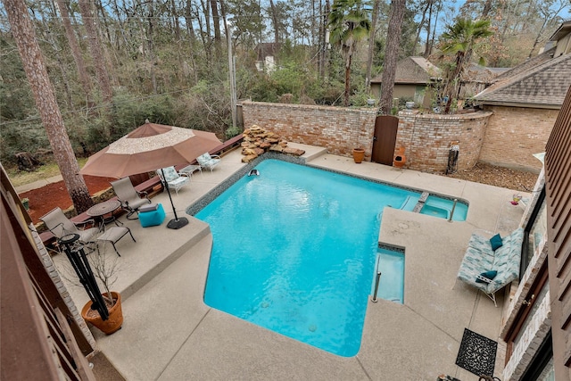 view of pool featuring an in ground hot tub and a patio