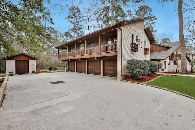 view of property exterior featuring a balcony and a garage