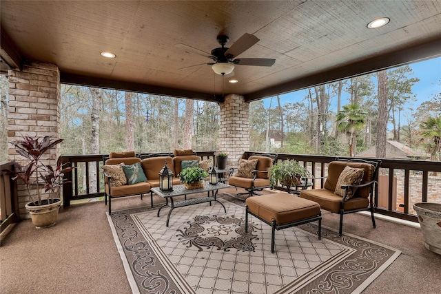 sunroom with ceiling fan and wood ceiling