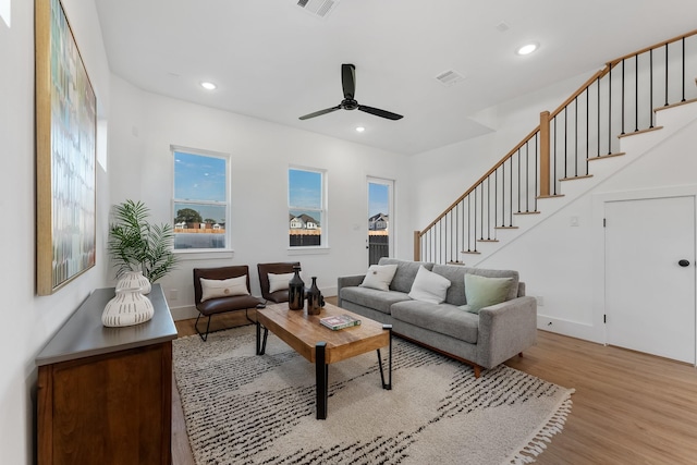 living room with ceiling fan and light wood-type flooring